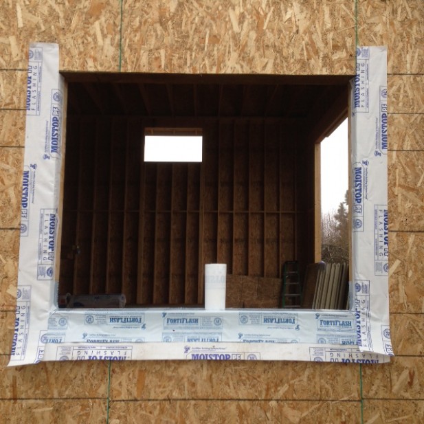 Sequence of proper window installation using self adhered membrane flashing, caulking and weather resistant barrier, new construction home