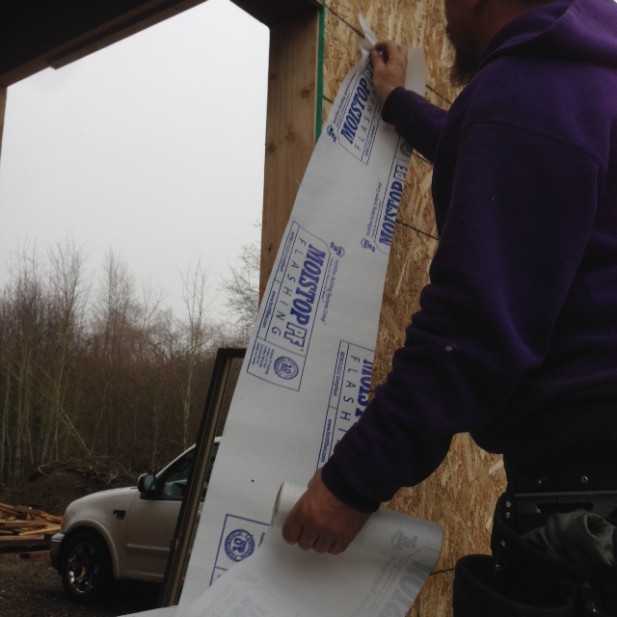 Sequence of proper window installation using self adhered membrane flashing, caulking and weather resistant barrier, new construction home